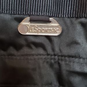 A Black Lesportsac over night bag lined.